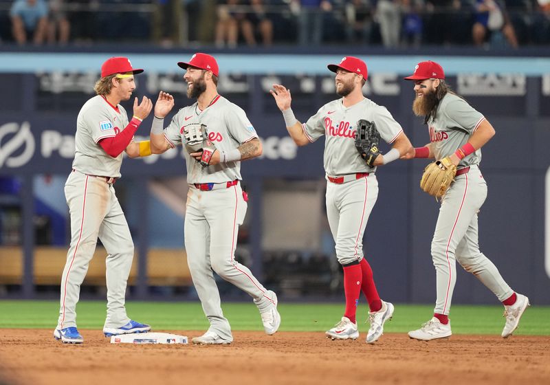 Sep 3, 2024; Toronto, Ontario, CAN; Philadelphia Phillies second base Bryson Stott (5) celebrates the win with Philadelphia Phillies outfielder Weston Wilson (37) against the Toronto Blue Jays at the end of the ninth inning at Rogers Centre. Mandatory Credit: Nick Turchiaro-Imagn Images