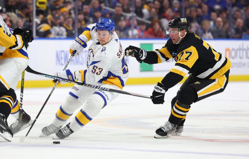 Dec 9, 2022; Buffalo, New York, USA;  Buffalo Sabres left wing Jeff Skinner (53) skates up ice with the puck as Pittsburgh Penguins center Jeff Carter (77) defends during the second period at KeyBank Center. Mandatory Credit: Timothy T. Ludwig-USA TODAY Sports