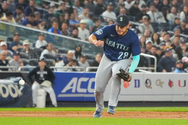 Jun 22, 2023; Bronx, New York, USA; Seattle Mariners third baseman Eugenio Suarez (28) fields a ground ball hit byt New York Yankees second baseman DJ LeMahieu (not pictured) during the sixth inning at Yankee Stadium. Mandatory Credit: Gregory Fisher-USA TODAY Sports