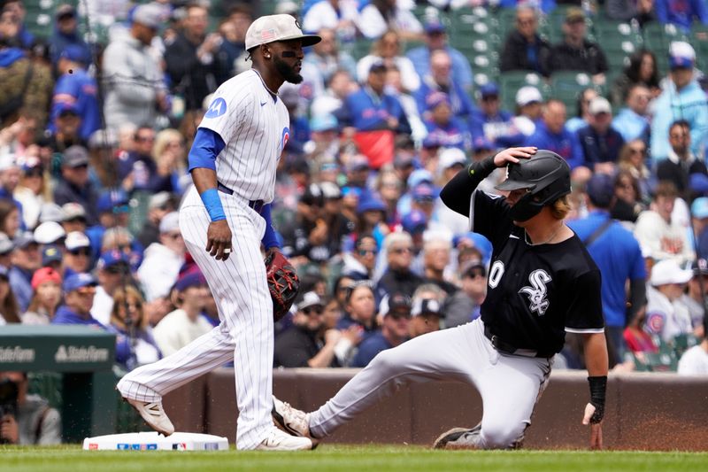 May 18, 2025; Chicago, Illinois, USA;Chicago White Sox shortstop Chase Meidroth (10) is safe at third base as Chicago Cubs third base Vidal Bruján (17) stands nearby during the first inning  at Wrigley Field. Mandatory Credit: David Banks-Imagn Images