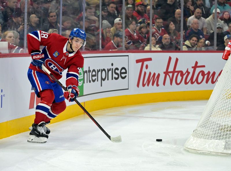 Nov 5, 2024; Montreal, Quebec, CAN; Montreal Canadiens defenseman Lane Hutson (48) plays the puck behind the net during the first period of the game against the Calgary Flames at the Bell Centre. Mandatory Credit: Eric Bolte-Imagn Images