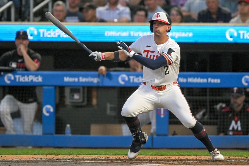 Sep 17, 2025; Minneapolis, Minnesota, USA;  Minnesota Twins infielder Brooks Lee (2) hits a single against the New York Yankees during the second inning at Target Field. Mandatory Credit: Nick Wosika-Imagn Images

