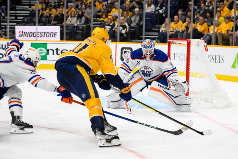 Oct 31, 2024; Nashville, Tennessee, USA;  Edmonton Oilers goaltender Calvin Pickard (30) blocks the shot of Nashville Predators center Steven Stamkos (91) during the third period at Bridgestone Arena. Mandatory Credit: Steve Roberts-Imagn Images