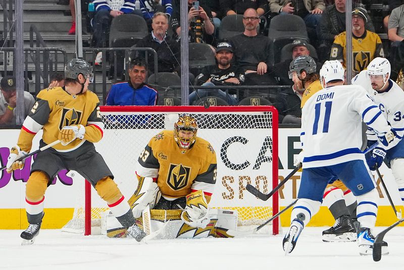 Jan 15, 2026; Las Vegas, Nevada, USA; Vegas Golden Knights goaltender Adin Hill (33) watches the puck after making a save against the Toronto Maple Leafs during the second period at T-Mobile Arena. Mandatory Credit: Stephen R. Sylvanie-Imagn Images