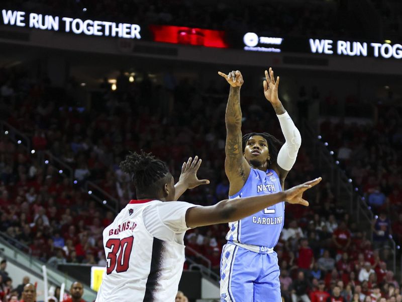 Feb 19, 2023; Raleigh, North Carolina, USA;  North Carolina Tar Heels guard Caleb Love (2) shoots a three point basket as North Carolina State Wolfpack forward D.J. Burns Jr. (30) defends during the second half of the game at PNC Arena. Mandatory Credit: Jaylynn Nash-USA TODAY Sports