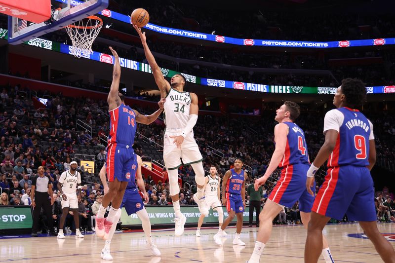DETROIT, MICHIGAN - JANUARY 20: Giannis Antetokounmpo #34 of the Milwaukee Bucks drives to the basket against Alec Burks #14 of the Detroit Pistons during the first half at Little Caesars Arena on January 20, 2024 in Detroit, Michigan. NOTE TO USER: User expressly acknowledges and agrees that, by downloading and or using this photograph, User is consenting to the terms and conditions of the Getty Images License  (Photo by Gregory Shamus/Getty Images)
