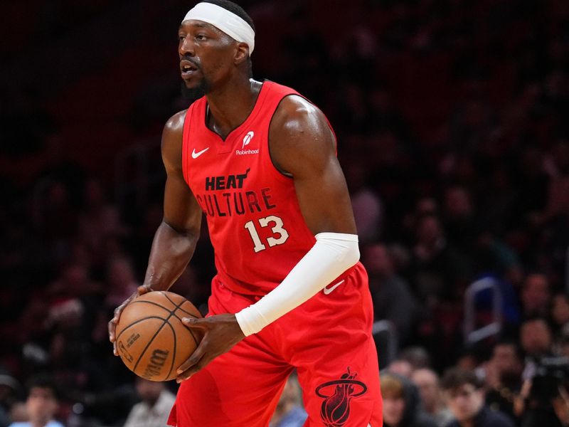 MIAMI, FLORIDA - DECEMBER 12: Bam Adebayo #13 of the Miami Heat looks to throw a pass against the Toronto Raptors during the first quarter at Kaseya Center on December 12, 2024 in Miami, Florida. NOTE TO USER: User expressly acknowledges and agrees that, by downloading and or using this Photograph, user is consenting to the terms and conditions of the Getty Images License Agreement. (Photo by Rich Storry/Getty Images)