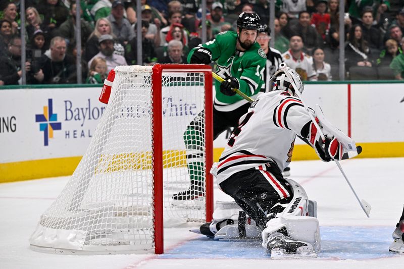 Oct 26, 2024; Dallas, Texas, USA; Dallas Stars left wing Jamie Benn (14) scores a goal against Chicago Blackhawks goaltender Petr Mrazek (34) during the second period at the American Airlines Center. Mandatory Credit: Jerome Miron-Imagn Images