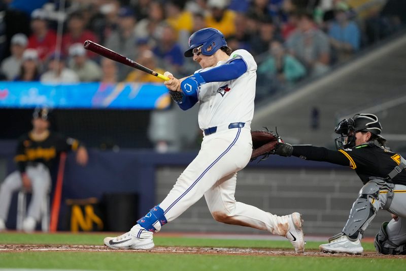 Jun 2, 2024; Toronto, Ontario, CAN; Toronto Blue Jays catcher Danny Jansen (9) hits a single against the Pittsburgh Pirates during the third inning at Rogers Centre. Mandatory Credit: John E. Sokolowski-USA TODAY Sports