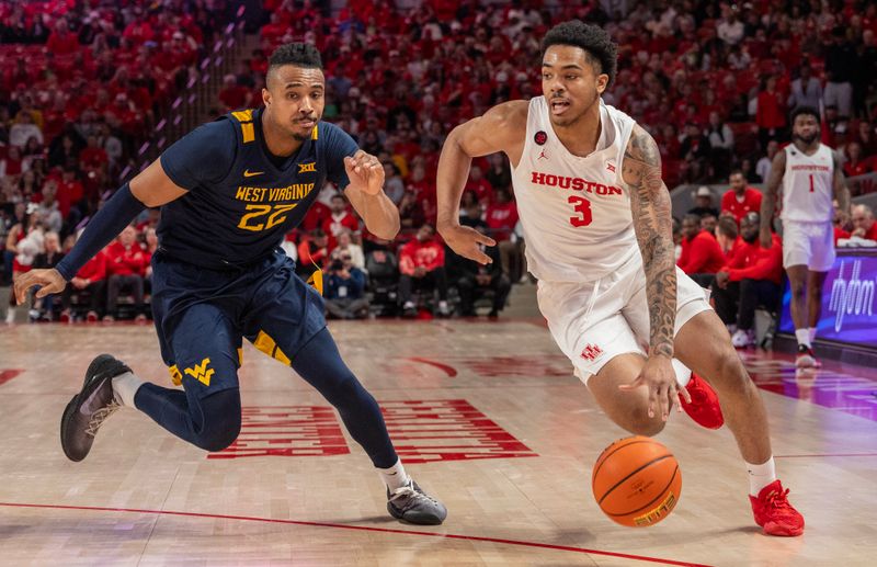 Jan 6, 2024; Houston, Texas, USA; Houston Cougars guard Ramon Walker Jr. (3) dribbles against West Virginia Mountaineers forward Josiah Harris (22) in the first half  at Fertitta Center. Mandatory Credit: Thomas Shea-USA TODAY Sports