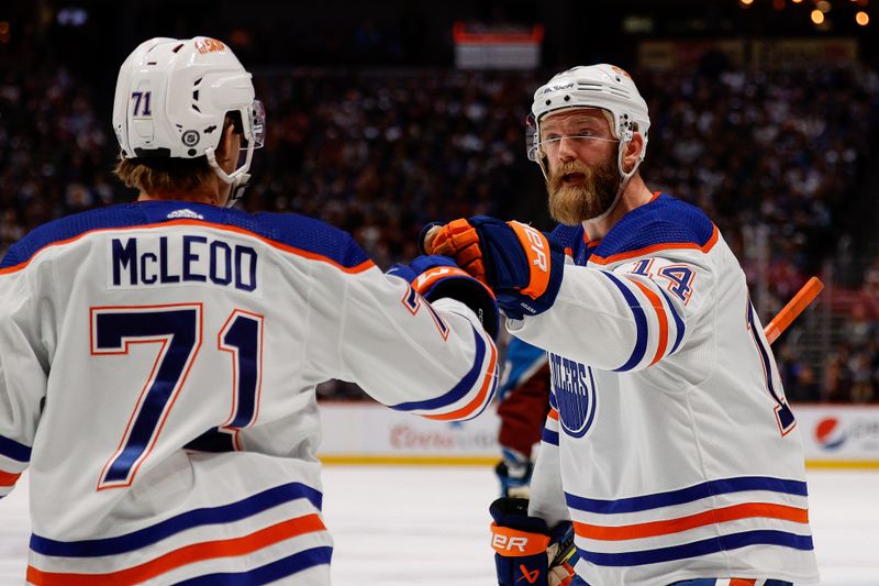 Apr 11, 2023; Denver, Colorado, USA; Edmonton Oilers defenseman Mattias Ekholm (14) celebrates the goal of center Ryan McLeod (71) in the first period against the Colorado Avalanche at Ball Arena. Mandatory Credit: Isaiah J. Downing-USA TODAY Sports