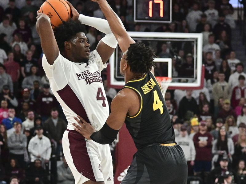 Feb 4, 2023; Starkville, Mississippi, USA; Mississippi State Bulldogs guard Cameron Matthews (4) handles the ball while defended by Missouri Tigers guard DeAndre Gholston (4) during the first half at Humphrey Coliseum. Mandatory Credit: Matt Bush-USA TODAY Sports