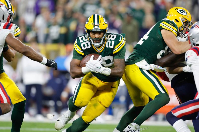 Green Bay Packers running back AJ Dillon (28) runs the ball during an NFL game against the New England Patriots Sunday, Oct. 2, 2022, in Green Bay, Wis. (AP Photo/Jeffrey Phelps)