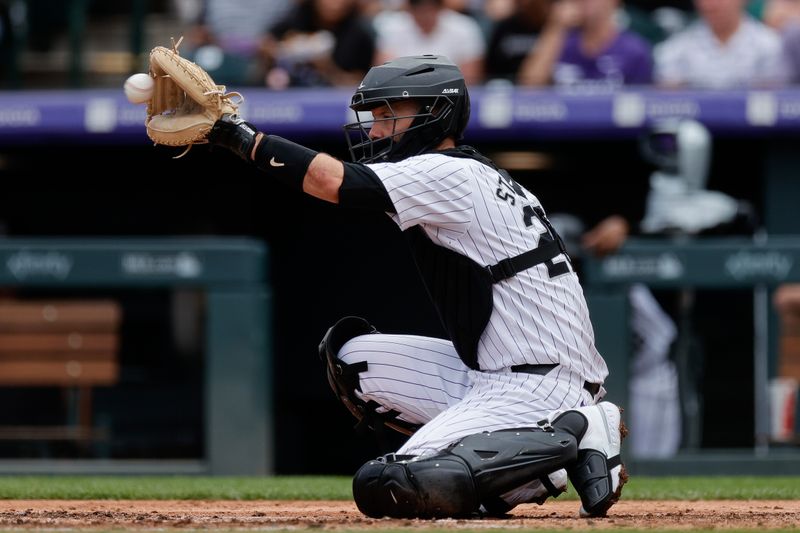 Aug 11, 2024; Denver, Colorado, USA; Colorado Rockies catcher Jacob Stallings (25) warms up a new pitcher in the fourth inning against the Atlanta Braves at Coors Field. Mandatory Credit: Isaiah J. Downing-USA TODAY Sports