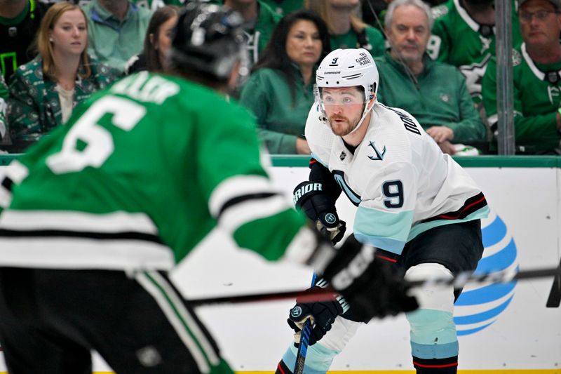 May 15, 2023; Dallas, Texas, USA; Seattle Kraken center Ryan Donato (9) looks to bring the puck up past Dallas Stars defenseman Colin Miller (6) during the first period in game seven of the second round of the 2023 Stanley Cup Playoffs at the American Airlines Center. Mandatory Credit: Jerome Miron-USA TODAY Sports