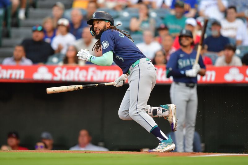 Jul 11, 2024; Anaheim, California, USA; Seattle Mariners shortstop J.P. Crawford (3) hits a ground rule double against the Los Angeles Angels during the first inning at Angel Stadium. Mandatory Credit: Gary A. Vasquez-USA TODAY Sports