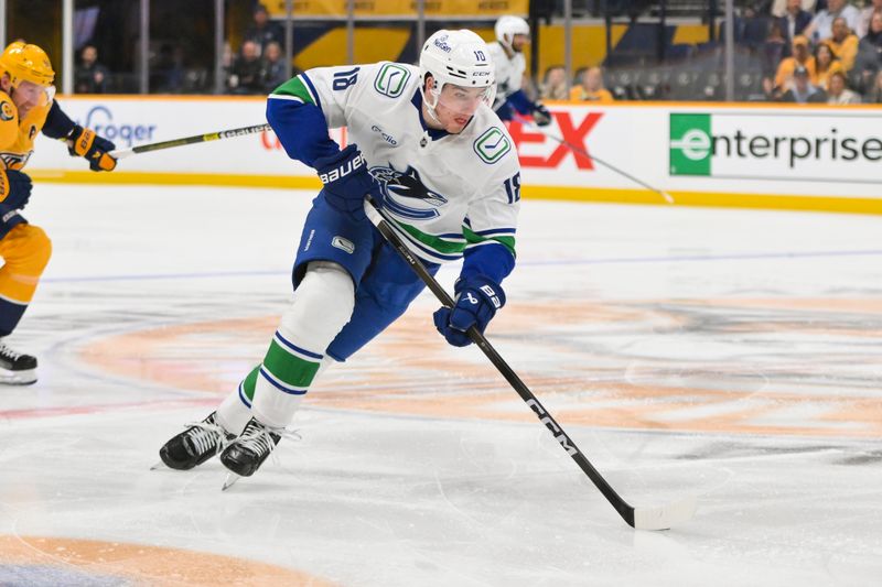Oct 23, 2025; Nashville, Tennessee, USA;  Vancouver Canucks left wing Drew O'Connor (18) skates with the puck against the Nashville Predators during the second period at Bridgestone Arena. Mandatory Credit: Steve Roberts-Imagn Images