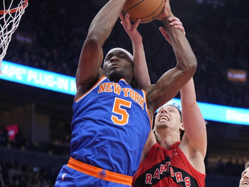 TORONTO, ON - MARCH 27: Precious Achiuwa #5 of the New York Knicks grabs a rebound against Kelly Olynyk #41 of the Toronto Raptors during the first half of their basketball game at the Scotiabank Arena on March 27, 2024 in Toronto, Ontario, Canada. NOTE TO USER: User expressly acknowledges and agrees that, by downloading and/or using this Photograph, user is consenting to the terms and conditions of the Getty Images License Agreement. (Photo by Mark Blinch/Getty Images)