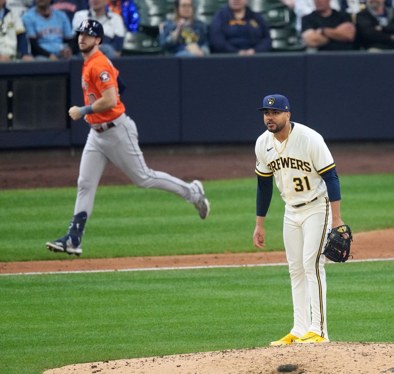 May 24, 2023; Milwaukee, Wisconsin, USA; Milwaukee Brewers relief pitcher Joel Payamps (31) watches as Houston Astros right fielder Kyle Tucker (30) lines out during the sixth inning at American Family Field. Mandatory Credit: Mark Hoffman-USA TODAY Sports