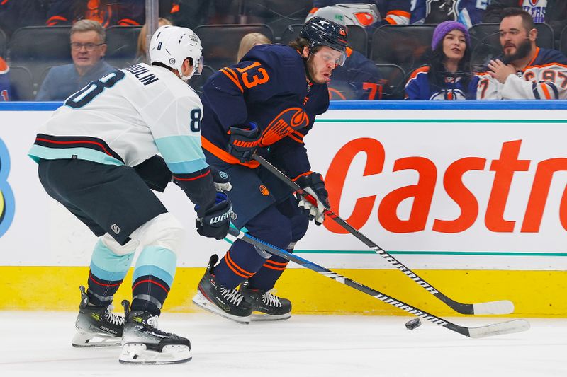 Jan 18, 2024; Edmonton, Alberta, CAN; Edmonton Oilers forward Mattias Janmark (13) looks to make a pass in front of Seattle Kraken defensemen Brian Dumoulin (8) during the first period at Rogers Place. Mandatory Credit: Perry Nelson-USA TODAY Sports