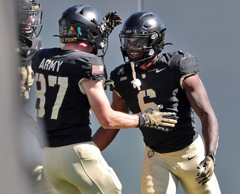 Oct 12, 2024; West Point, New York, USA; Army Black Knights running back Kanye Udoh (6) celebrates his touchdown run with wide receiver Casey Reynolds (87) during the first half against the UAB Blazers at Michie Stadium. Mandatory Credit: Danny Wild-Imagn Images