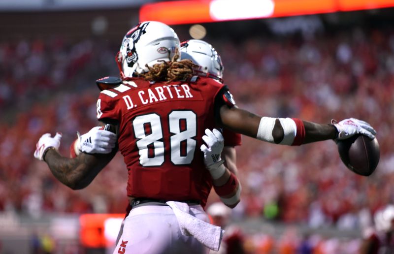 Sep 25, 2021; Raleigh, North Carolina, USA; North Carolina State Wolfpack wide receiver Devin Carter (88) celebrates a touchdown in the second overtime period against the Clemson Tigers at Carter-Finley Stadium. Mandatory Credit: Rob Kinnan-USA TODAY Sports