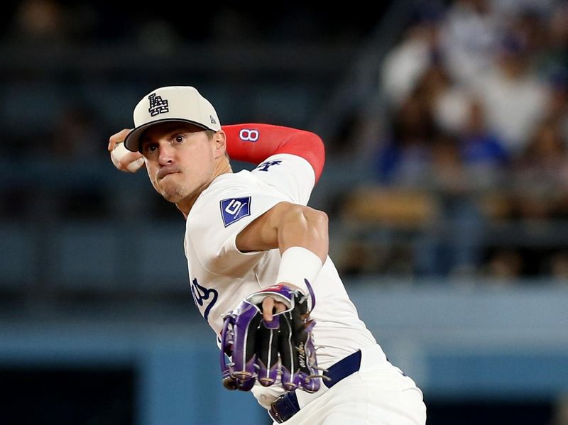 Jul 4, 2024; Los Angeles, California, USA; Los Angeles Dodgers third baseman Enrique Hernandez (8) throws to first for an out during the ninth inning against the Arizona Diamondbacks at Dodger Stadium. Mandatory Credit: Jason Parkhurst-USA TODAY Sports