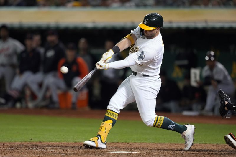 Sep 6, 2024; Oakland, California, USA; Oakland Athletics left fielder Seth Brown (15) hits a home run against the Detroit Tigers during the eleventh inning at Oakland-Alameda County Coliseum. Mandatory Credit: Darren Yamashita-Imagn Images