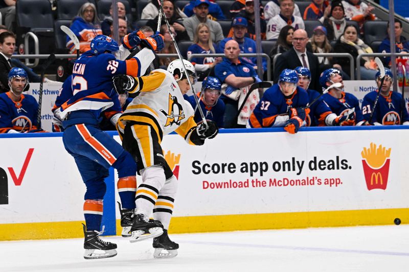 Apr 17, 2024; Elmont, New York, USA;  New York Islanders center Kyle MacLean (32) and Pittsburgh Penguins defenseman Jack St. Ivany (3) coillide during the first period at UBS Arena. Mandatory Credit: Dennis Schneidler-USA TODAY Sports