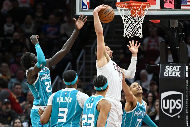 CLEVELAND, OHIO - APRIL 14: Max Strus #1 of the Cleveland Cavaliers rebounds a shot against JT Thor #21, Marques Bolden #3, Tre Mann #23 and Bryce McGowens #7 of the Charlotte Hornets during the second half at Rocket Mortgage Fieldhouse on April 14, 2024 in Cleveland, Ohio. NOTE TO USER: User expressly acknowledges and agrees that, by downloading and or using this photograph, User is consenting to the terms and conditions of the Getty Images License Agreement. (Photo by Nick Cammett/Getty Images)