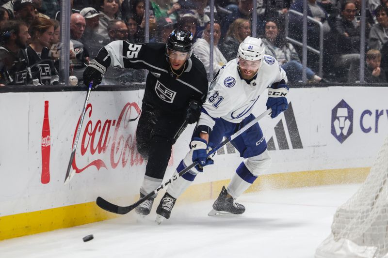 Mar 23, 2024; Los Angeles, California, USA; Los Angeles Kings center Quinton Byfield (55) and Tampa Bay Lighting defensemen Erik Cernak (81) make a play on the puck during the second period of an NHL hockey game at Crypto.com Arena. Mandatory Credit: Yannick Peterhans-USA TODAY Sports