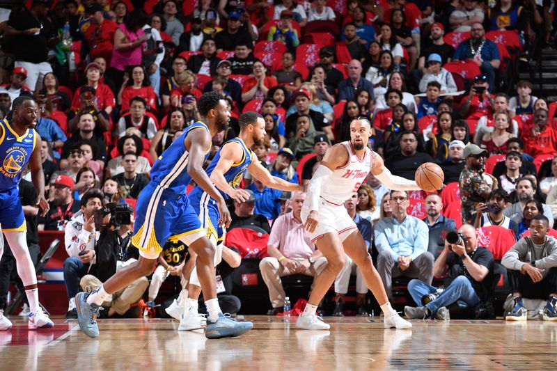 HOUSTON, TX - APRIL 4: Dillon Brooks #9 of the Houston Rockets handles the ball against Andrew Wiggins #22, Stephen Curry #30 and Draymond Green #23 of the Golden State Warriors during the game on April 4, 2024 at the Toyota Center in Houston, Texas. NOTE TO USER: User expressly acknowledges and agrees that, by downloading and or using this photograph, User is consenting to the terms and conditions of the Getty Images License Agreement. Mandatory Copyright Notice: Copyright 2024 NBAE (Photo by Logan Riely/NBAE via Getty Images)