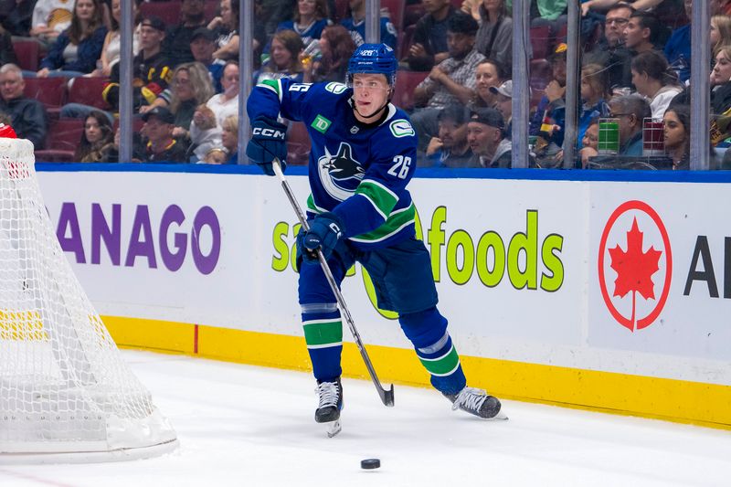 Sep 24, 2024; Vancouver, British Columbia, CAN; Vancouver Canucks defenseman Elias Pettersson (26) makes a save against the Seattle Kraken during the second period at Rogers Arena. Mandatory Credit: Bob Frid-Imagn Images