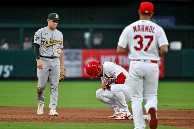 Aug 14, 2023; St. Louis, Missouri, USA;  St. Louis Cardinals catcher Willson Contreras (40) knees on second base after an injury as manager Oliver Marmol (37) runs to check on him during the third inning against the Oakland Athletics at Busch Stadium. Wilson would leave the game after the third inning. Mandatory Credit: Jeff Curry-USA TODAY Sports