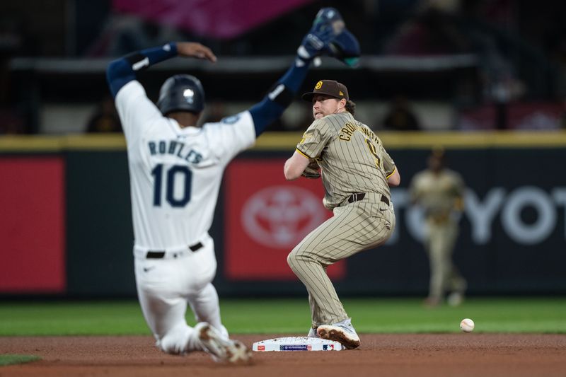 Sep 11, 2024; Seattle, Washington, USA;  San Diego Padres second baseman Jake Cronenworth (9) is unable to turn a double play as Seattle Mariners right fielder Victor Robles (10) slides safely into second base during the third inning at T-Mobile Park. Mandatory Credit: Stephen Brashear-Imagn Images