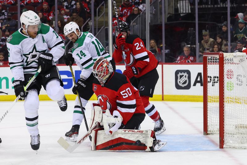 Jan 20, 2024; Newark, New Jersey, USA; New Jersey Devils goaltender Nico Daws (50) makes a save against the Dallas Stars during the first period at Prudential Center. Mandatory Credit: Ed Mulholland-USA TODAY Sports