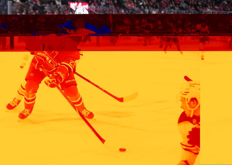 Jan 22, 2026; Montreal, Quebec, CAN;  Montreal Canadiens defenseman Kaiden Guhle (21) plays the puck against Buffalo Sabres defenseman Owen Power (25) during the third period at the Bell Centre. Mandatory Credit: Eric Bolte-Imagn Images