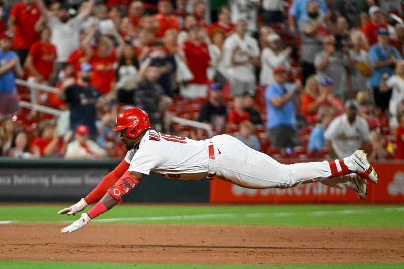 Aug 14, 2023; St. Louis, Missouri, USA;  St. Louis Cardinals right fielder Jordan Walker (18) slides head first in at third base after hitting a go-ahead three run triple against the Oakland Athletics during the seventh inning at Busch Stadium. Mandatory Credit: Jeff Curry-USA TODAY Sports