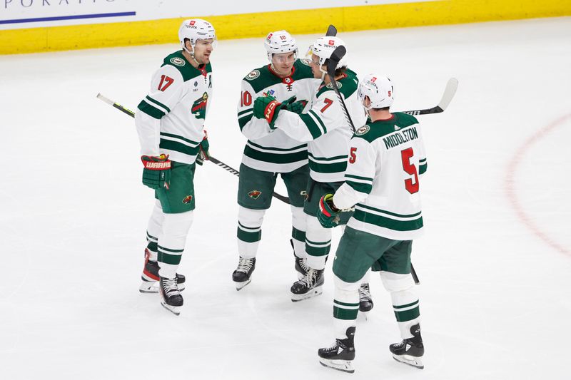 Feb 7, 2024; Chicago, Illinois, USA; Minnesota Wild left wing Marcus Foligno (17) celebrates with teammates after scoring against the Chicago Blackhawks during the third period at United Center. Mandatory Credit: Kamil Krzaczynski-USA TODAY Sports