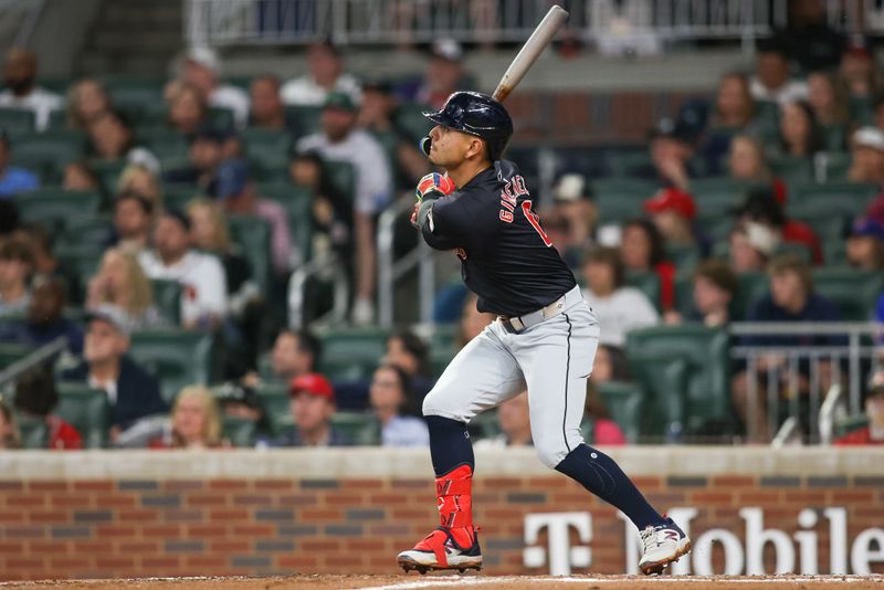 Apr 27, 2024; Atlanta, Georgia, USA; Cleveland Guardians second baseman Andres Gimenez (0) hits a single against the Atlanta Braves in the sixth inning at Truist Park. Mandatory Credit: Brett Davis-USA TODAY Sports