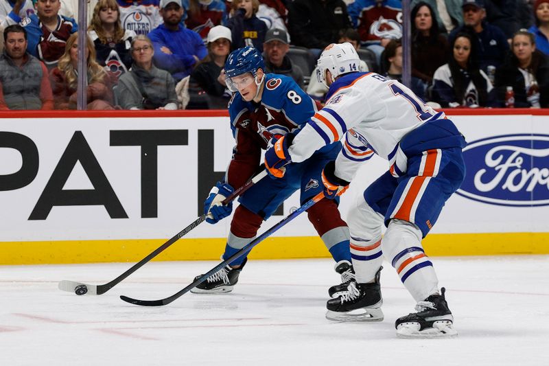 Jan 16, 2025; Denver, Colorado, USA; Colorado Avalanche defenseman Cale Makar (8) controls the puck as Edmonton Oilers defenseman Mattias Ekholm (14) defends in the second period at Ball Arena. Mandatory Credit: Isaiah J. Downing-Imagn Images