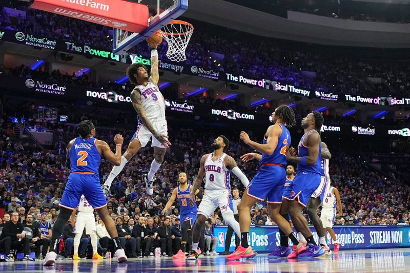 PHILADELPHIA, PENNSYLVANIA - JANUARY 15: Kelly Oubre Jr. #9 of the Philadelphia 76ers dunks the ball against Miles McBride #2 and Jericho Sims #20 of the New York Knicks in the first half at the Wells Fargo Center on January 15, 2025 in Philadelphia, Pennsylvania. NOTE TO USER: User expressly acknowledges and agrees that, by downloading and/or using this photograph, user is consenting to the terms and conditions of the Getty Images License Agreement. (Photo by Mitchell Leff/Getty Images)