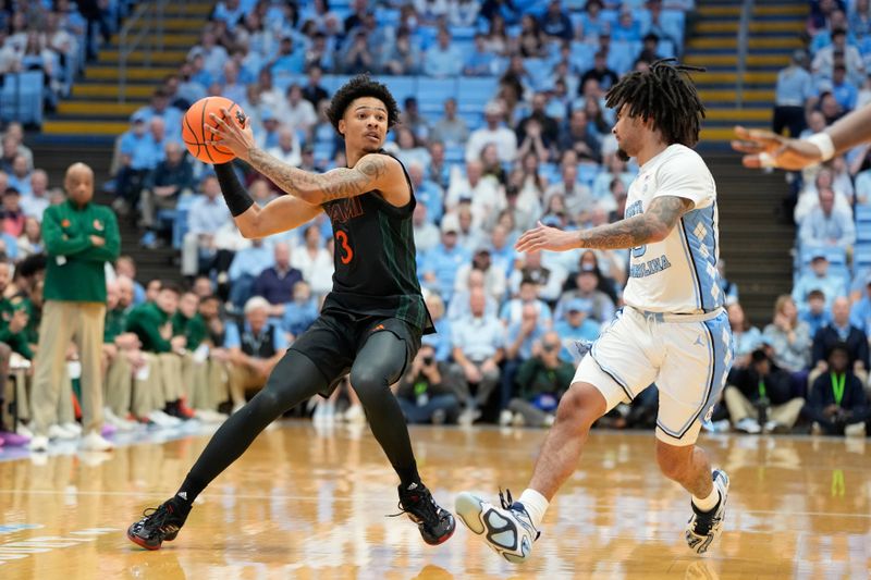 Mar 1, 2025; Chapel Hill, North Carolina, USA;  Miami (Fl) Hurricanes guard Jalil Bethea (3) with the ball as North Carolina Tar Heels guard Elliot Cadeau (3) defends in the first half at Dean E. Smith Center. Mandatory Credit: Bob Donnan-Imagn Images