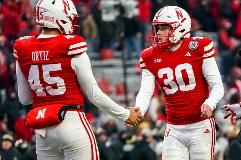 Oct 28, 2023; Lincoln, Nebraska, USA; Nebraska Cornhuskers place kicker Tristan Alvano (30) and long snapper Marco Ortiz (45) celebrate after an extra point during the fourth quarter against the Purdue Boilermakers at Memorial Stadium. Mandatory Credit: Dylan Widger-USA TODAY Sports