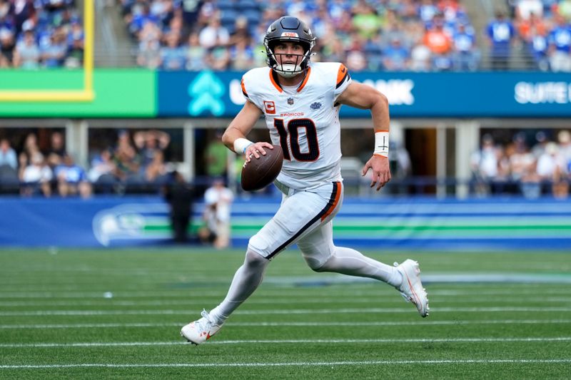 Denver Broncos quarterback Bo Nix (10) runs for a touchdown during the second half of an NFL football game against the Seattle Seahawks, Sunday, Sept. 8, 2024, in Seattle. (AP Photo/Lindsey Wasson)