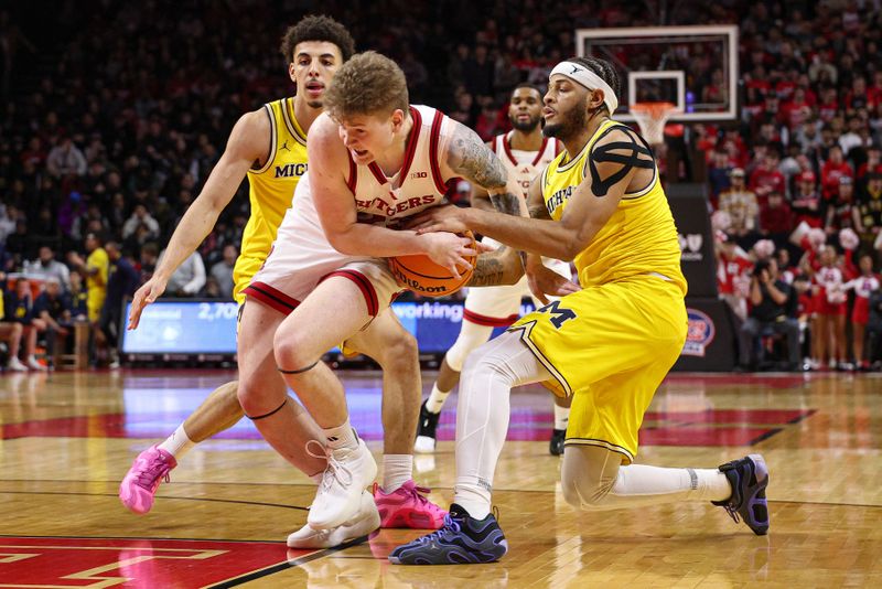 Feb 1, 2025; Piscataway, New Jersey, USA; Rutgers Scarlet Knights guard PJ Hayes IV (23) is tied up by Michigan Wolverines guard Roddy Gayle Jr. (11) during the second half at Jersey Mike's Arena. Mandatory Credit: Vincent Carchietta-Imagn Images