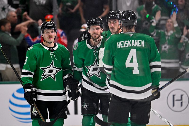 Oct 12, 2024; Dallas, Texas, USA; Dallas Stars center Sam Steel (18) and center Tyler Seguin (91) and left wing Mason Marchment (27) and defenseman Miro Heiskanen (4) celebrates an empty net goal scored Seguin against the New York Islanders by during the third period at the American Airlines Center. Mandatory Credit: Jerome Miron-Imagn Images