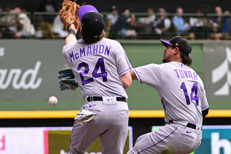 Aug 9, 2023; Milwaukee, Wisconsin, USA; Colorado Rockies shortstop Ezequiel Tovar (14) and third baseman Ryan McMahon (24) cannot catch a foul ball hit by Milwaukee Brewers right fielder Sal Frelick (not pictured) in the fifth inning at American Family Field. Mandatory Credit: Benny Sieu-USA TODAY Sports