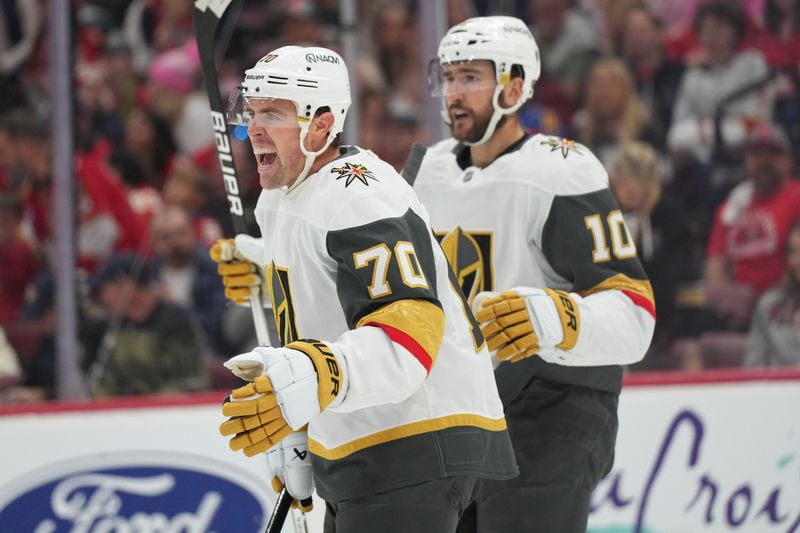 Oct 19, 2024; Sunrise, Florida, USA;  Vegas Golden Knights left wing Tanner Pearson (70) celebrates with center Nicolas Roy (10) after a goal against the Florida Panthers during the first period at Amerant Bank Arena. Mandatory Credit: Jim Rassol-Imagn Images