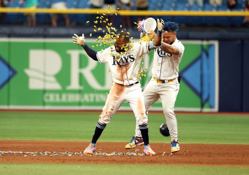 Sep 21, 2023; St. Petersburg, Florida, USA; Tampa Bay Rays center fielder Manuel Margot (13) celebrated by getting gum dumped on him by designated hitter Harold Ramirez (43) after he hit the game winning walk off RBI during the ninth inning against the Los Angeles Angels at Tropicana Field. Mandatory Credit: Kim Klement Neitzel-USA TODAY Sports